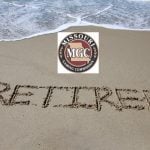 The word 'retired' written in the sand