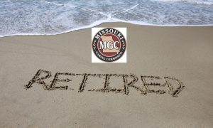 The word 'retired' written in the sand
