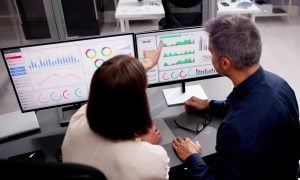 Analysts looking at data on a computer