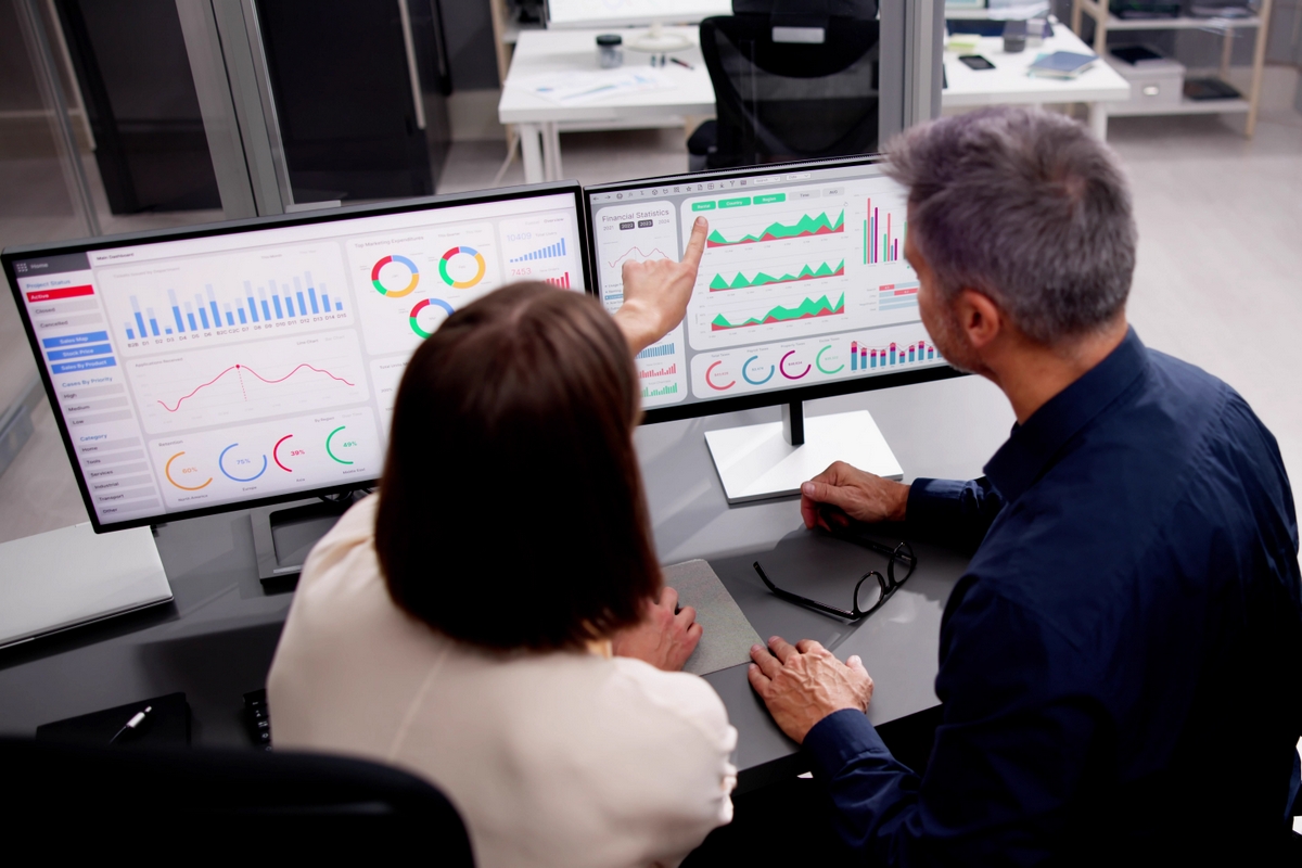Analysts looking at data on a computer