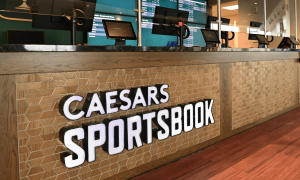 Caesars Sportsbook logo on wood display
