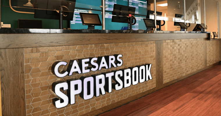 Caesars Sportsbook logo on wood display