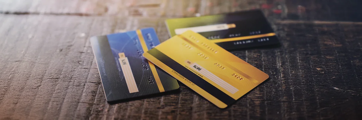 Visa and Mastercard credit cards on a wooden table used for online gambling deposit