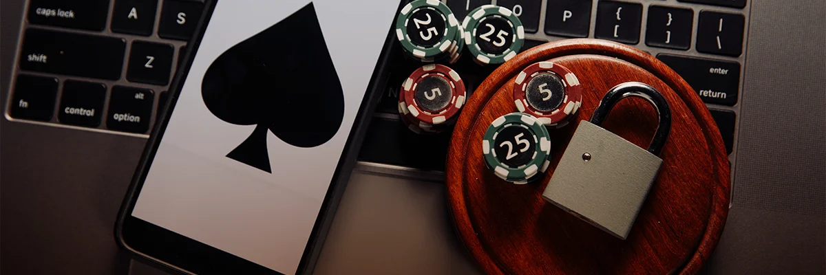 Casino chips, a smartphone with a spade symbol, and a padlock representing secure and responsible online gambling banking